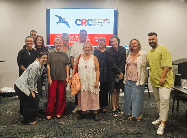 buttery training Photograph of 12 people smiling in front of a presentation monitor with CRC logo.